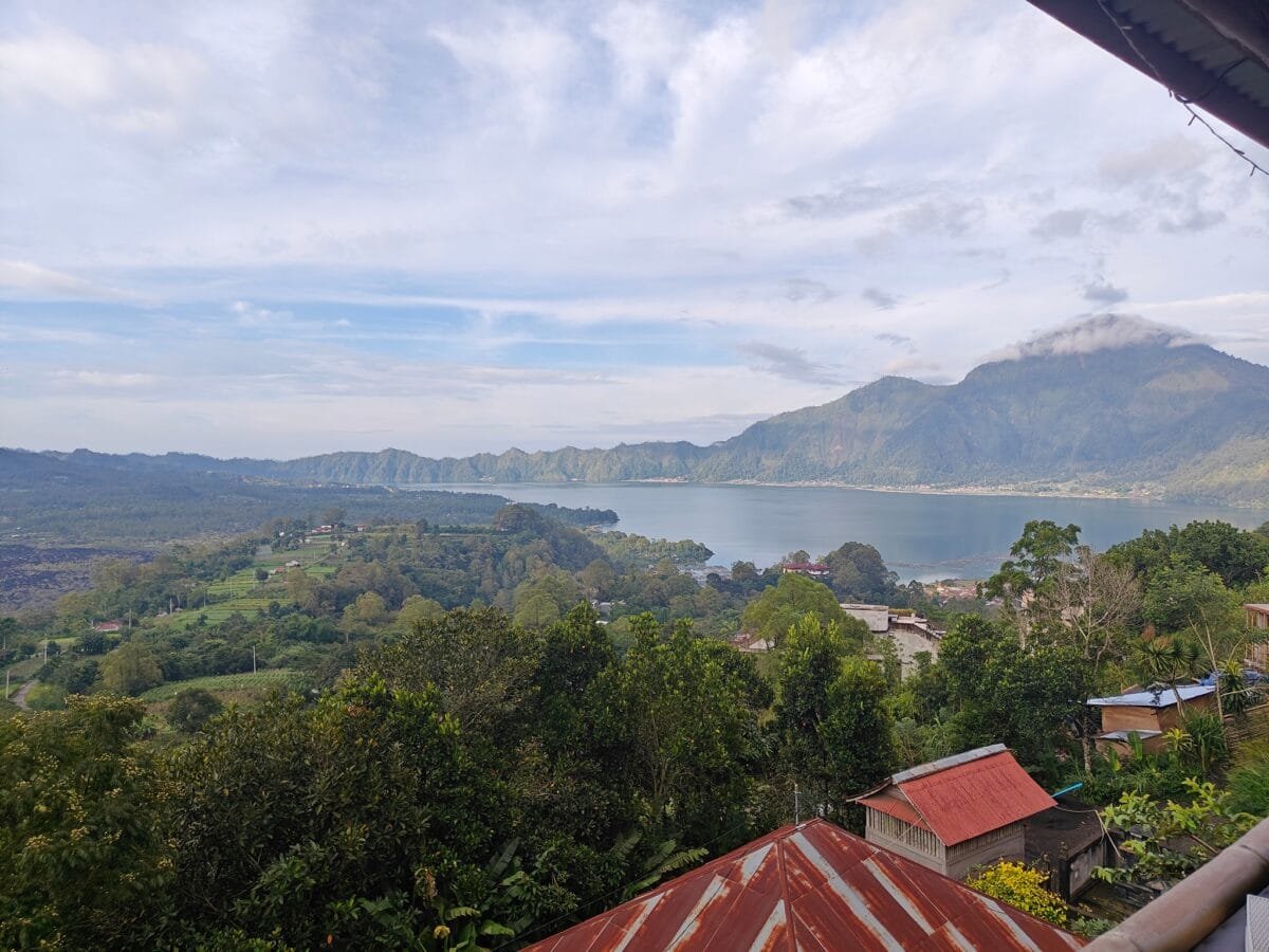 The serene Lake Batur surrounded by green hills in Bangli.