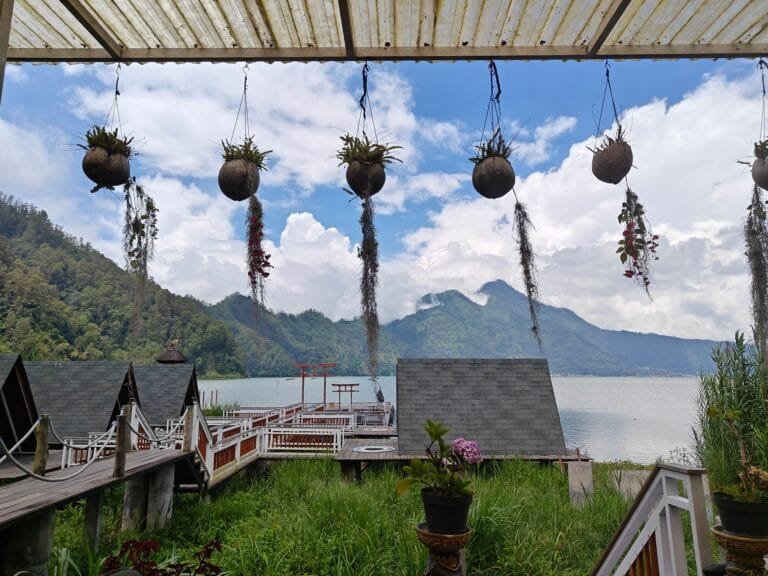 The serene Lake Batur surrounded by green hills in Bangli.