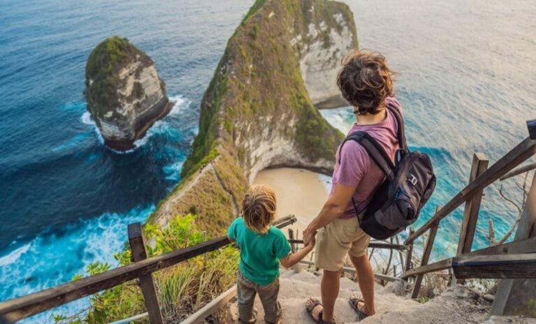 Aerial view of Kelingking Beach in Nusa Penida with turquoise waters and rugged cliffs.